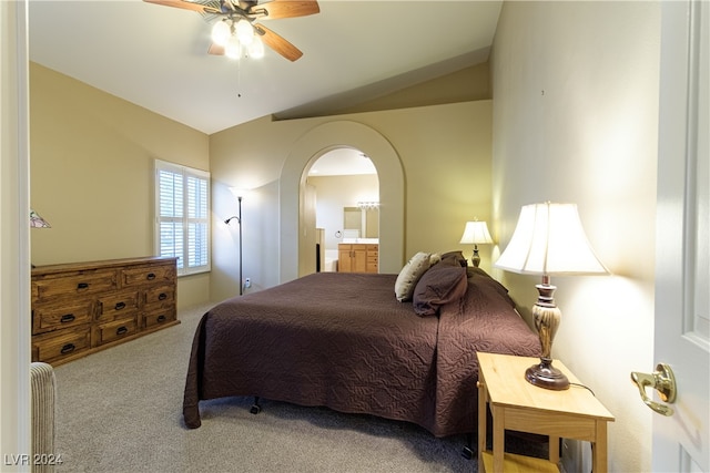 bedroom featuring ceiling fan, lofted ceiling, ensuite bathroom, and carpet