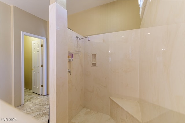 bathroom with a tile shower