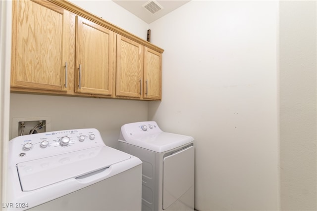 laundry area featuring cabinets and washing machine and clothes dryer