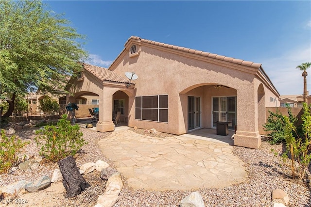1214 Country Club Dr, Laughlin, NV 89029 - back of property featuring a tiled roof, stucco siding, fence, and a patio
