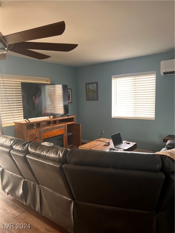 living room with wood-type flooring, ceiling fan, and a wall mounted air conditioner