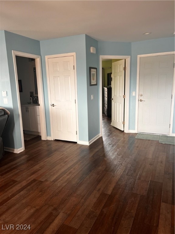 unfurnished room with dark hardwood / wood-style floors