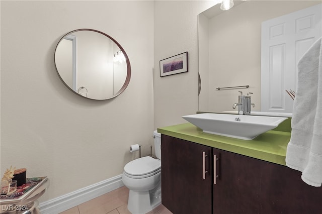 bathroom with tile patterned flooring, vanity, and toilet