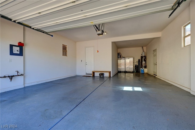 garage with a garage door opener and water heater