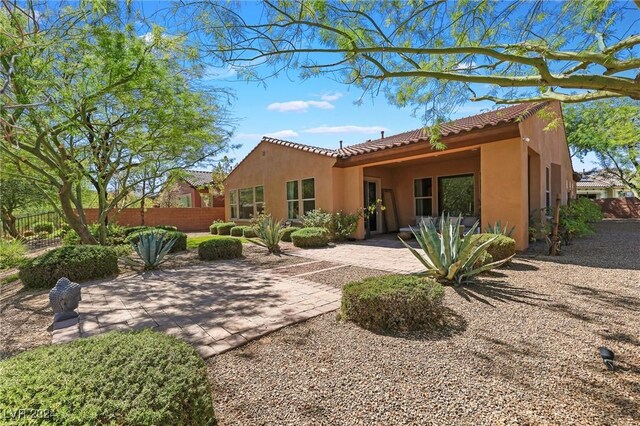 6 Lago Turchino Ct, Henderson, NV 89011 - rear view of house with a patio area, a tiled roof, fence, and stucco siding