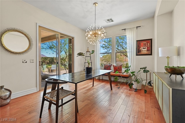 dining room with a notable chandelier and light hardwood / wood-style flooring