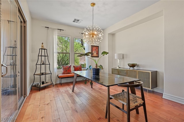 interior space featuring light hardwood / wood-style flooring and a notable chandelier