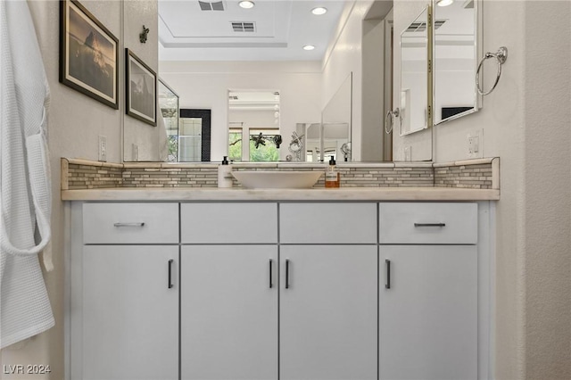 6 Lago Turchino Ct, Henderson, NV 89011 - bathroom with tasteful backsplash, vanity, recessed lighting, visible vents, and a tray ceiling