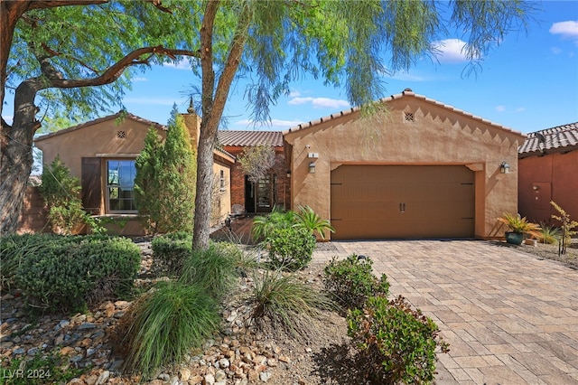 mediterranean / spanish home with a garage