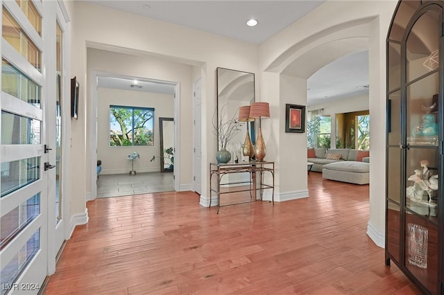 6 Lago Turchino Ct, Henderson, NV 89011 - hall with a wealth of natural light, arched walkways, and light wood-type flooring