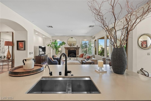 6 Lago Turchino Ct, Henderson, NV 89011 - kitchen with a sink, open floor plan, light countertops, and a fireplace