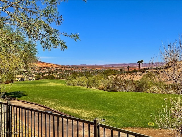 view of community with a lawn and a mountain view