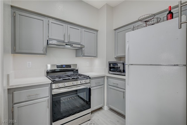 kitchen with appliances with stainless steel finishes and gray cabinets