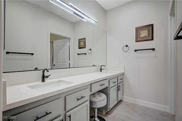 bathroom with hardwood / wood-style floors and vanity