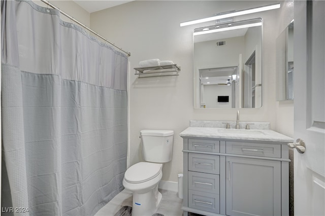 bathroom with vanity, tile patterned floors, toilet, and a shower with shower curtain