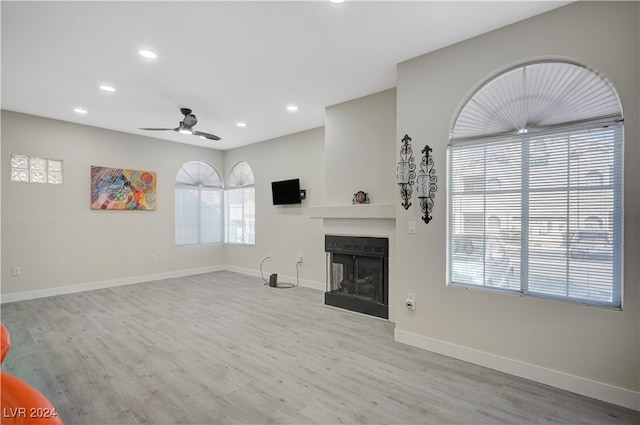 unfurnished living room with light hardwood / wood-style flooring and ceiling fan