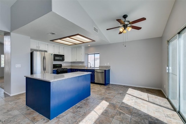 kitchen featuring vaulted ceiling, a center island, black appliances, white cabinetry, and blue cabinets