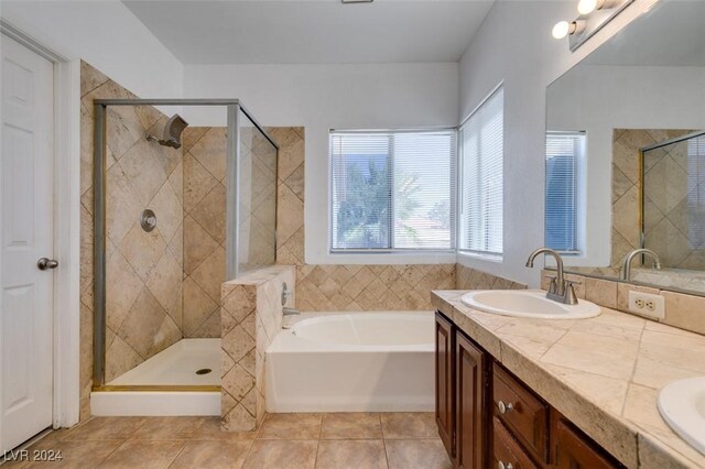 bathroom featuring vanity, independent shower and bath, and tile patterned flooring