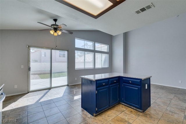 kitchen with ceiling fan, a kitchen island, lofted ceiling, and blue cabinetry