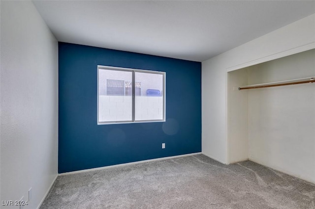 unfurnished bedroom featuring a closet and carpet floors