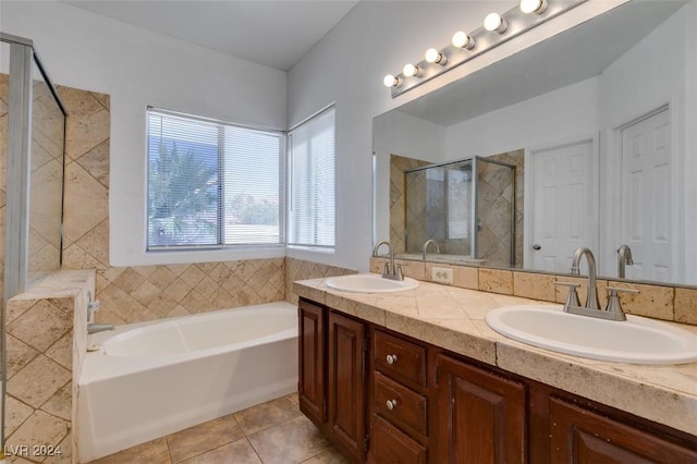 bathroom with plus walk in shower, tile patterned floors, and vanity