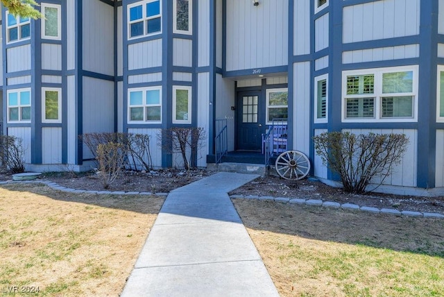 view of exterior entry featuring a yard
