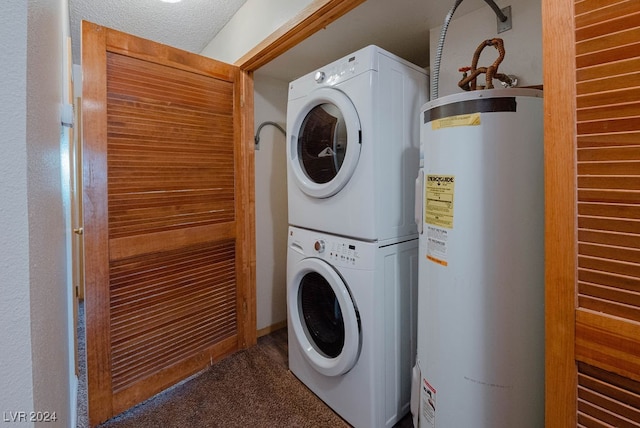 washroom with water heater, a textured ceiling, and stacked washer / drying machine