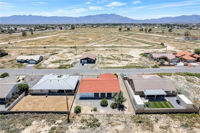 birds eye view of property with a mountain view