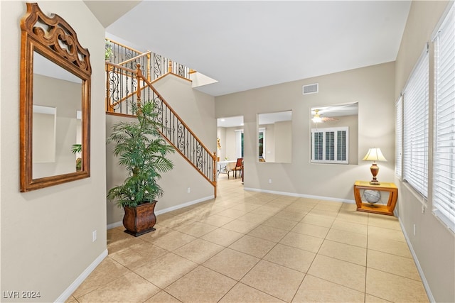 tiled entrance foyer featuring ceiling fan