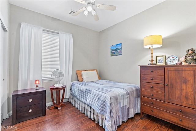 bedroom with ceiling fan and dark hardwood / wood-style flooring