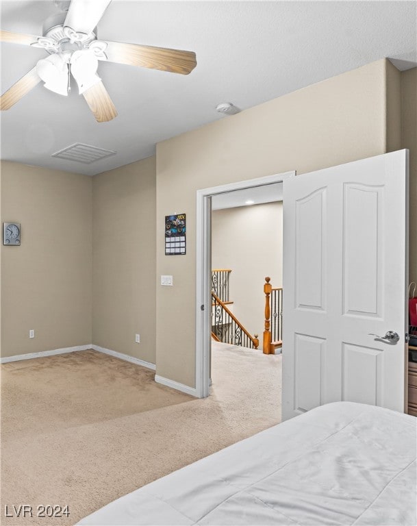 bedroom featuring ceiling fan and light carpet