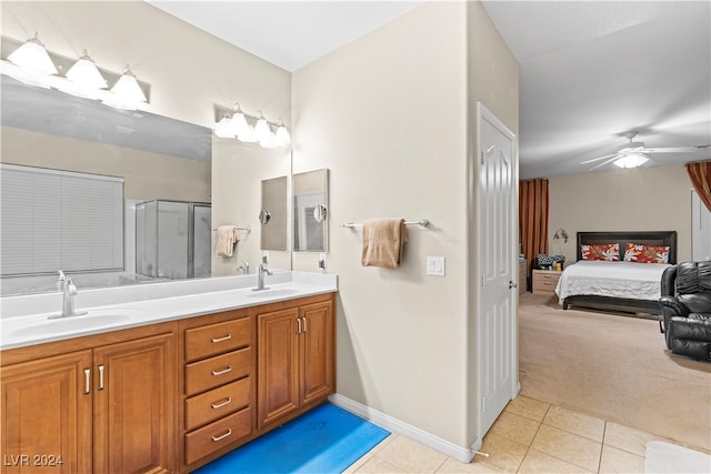 bathroom with ceiling fan, tile patterned flooring, vanity, and walk in shower