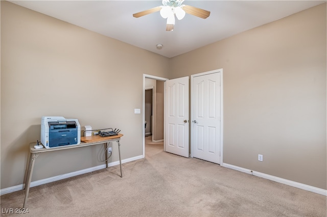 carpeted office featuring ceiling fan