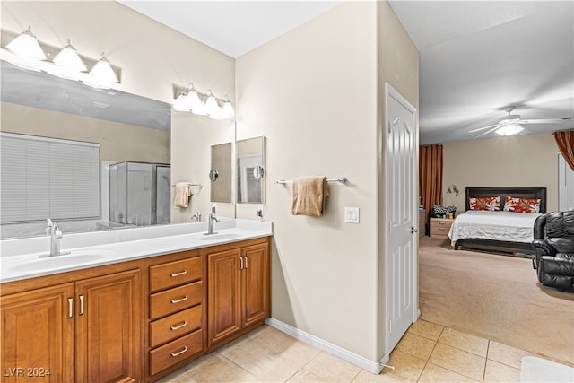 bathroom featuring tile patterned floors, ceiling fan, a shower with shower door, and vanity