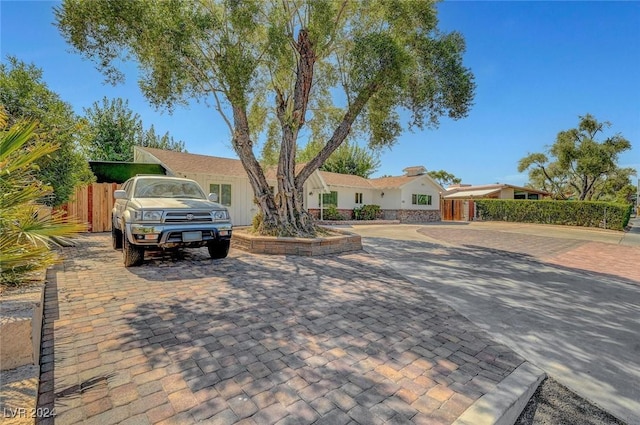 ranch-style house with fence