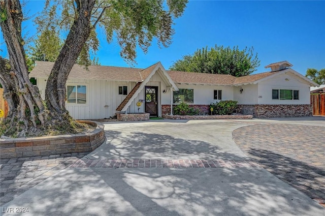 view of front of house with brick siding and decorative driveway