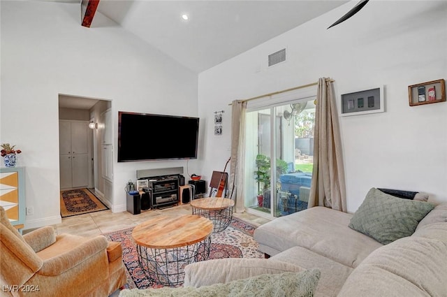 living area with high vaulted ceiling, baseboards, light tile patterned floors, and visible vents