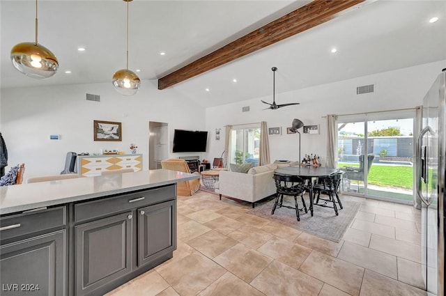 kitchen featuring decorative light fixtures, light countertops, visible vents, open floor plan, and stainless steel fridge with ice dispenser