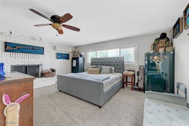 bedroom with a ceiling fan, light colored carpet, a fireplace, and a wall mounted AC