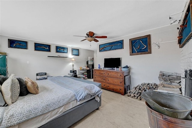 bedroom with a ceiling fan and light colored carpet