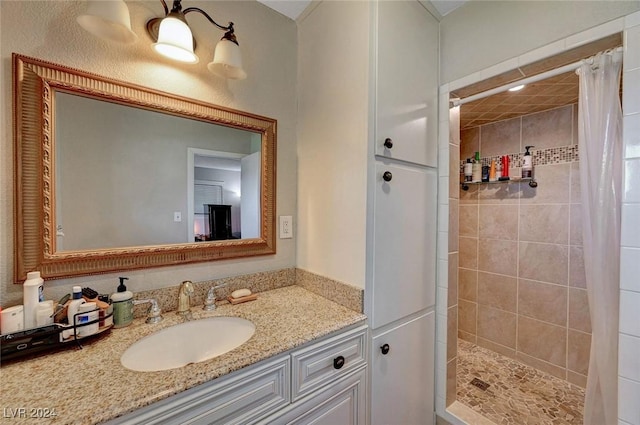 bathroom with a stall shower and vanity