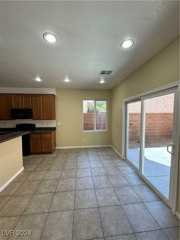 kitchen featuring a textured ceiling and light tile patterned floors