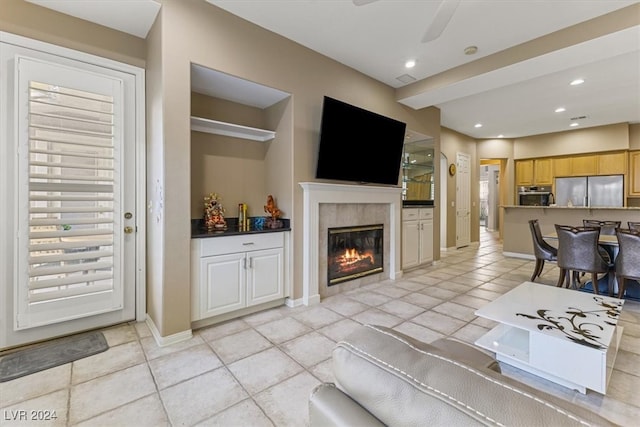 living room featuring ceiling fan and light tile patterned floors