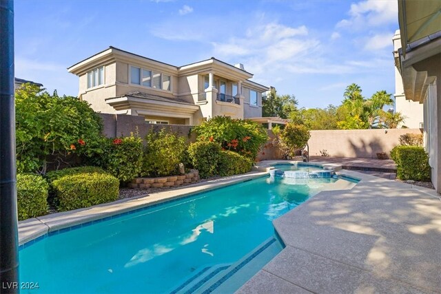 view of swimming pool with an in ground hot tub and a patio