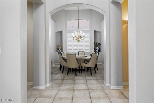 dining area featuring light tile patterned floors and a chandelier