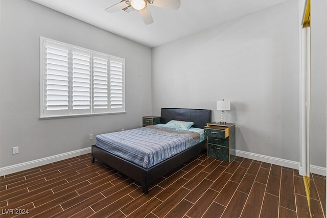 bedroom with ceiling fan and dark hardwood / wood-style floors