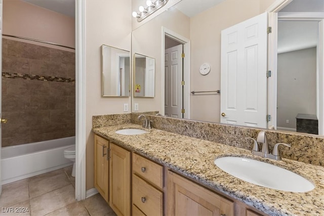 full bathroom with tiled shower / bath combo, vanity, tile patterned flooring, and toilet