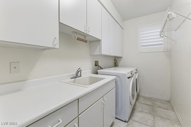 laundry room with cabinets, sink, and washing machine and clothes dryer