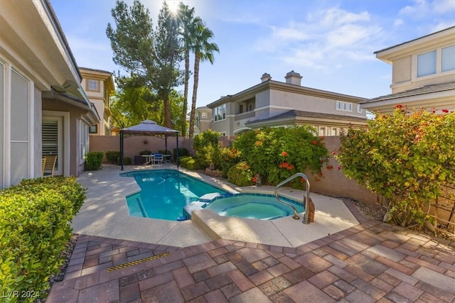 view of pool featuring a patio, a gazebo, and an in ground hot tub