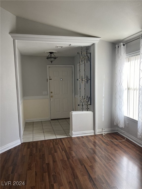 entrance foyer featuring hardwood / wood-style floors and lofted ceiling